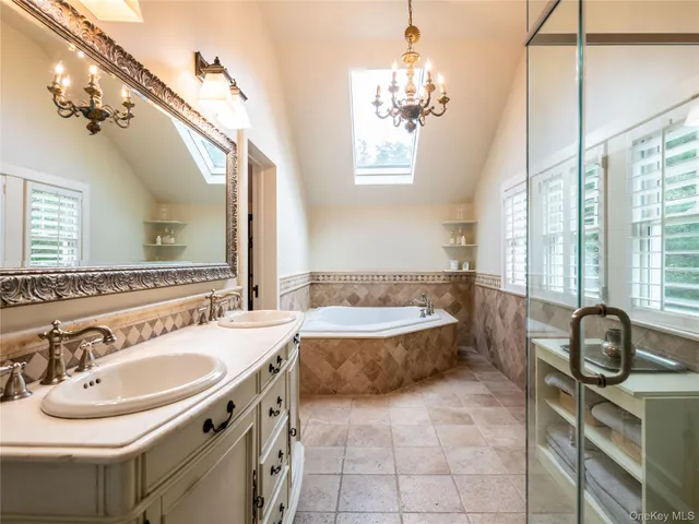 a bathroom with a sink a toilet a mirror and window