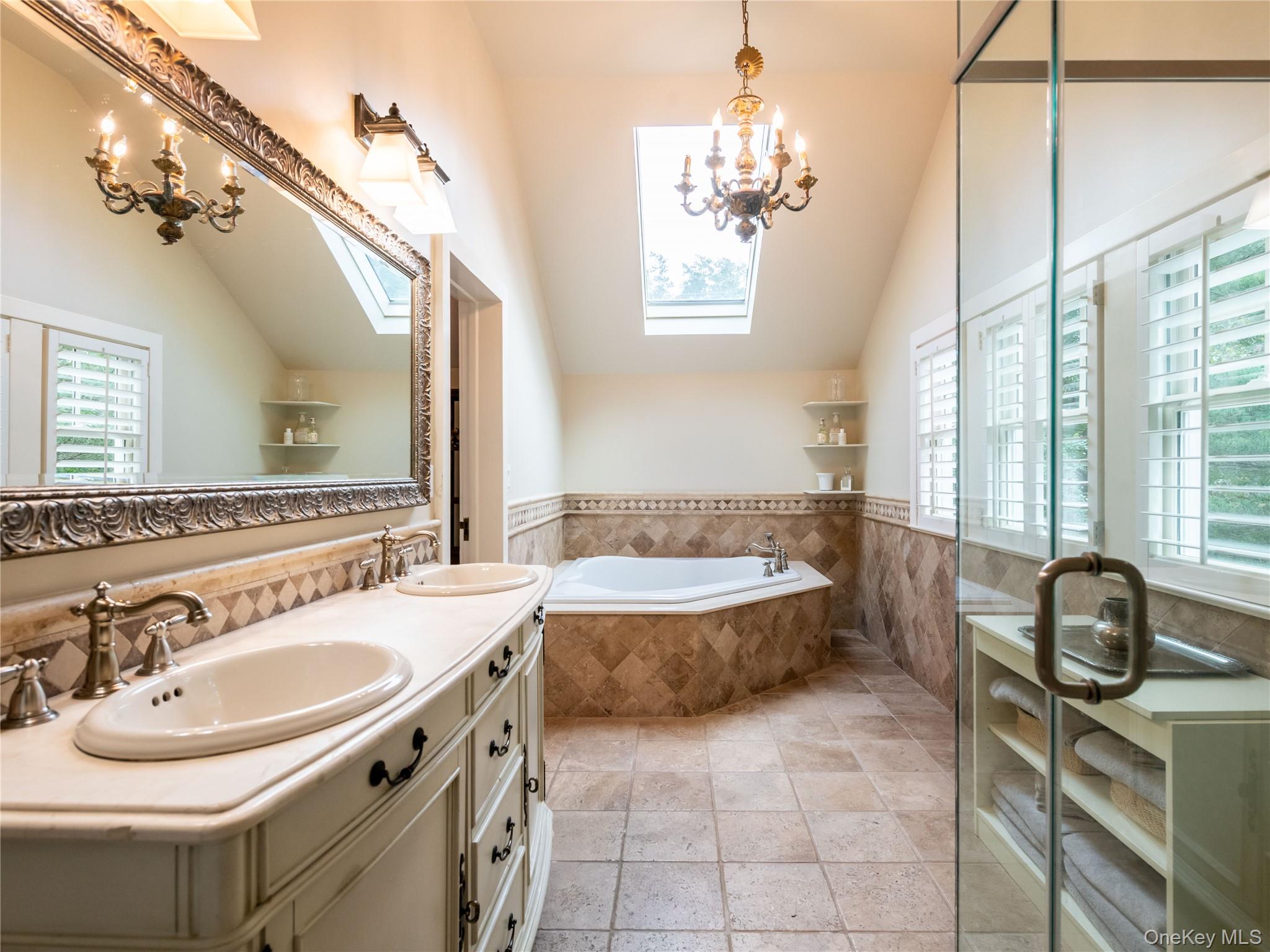 1054 Plandome Road Manhasset, NY 11030 - Photo 14 of 47 a bathroom with a sink a toilet a mirror and window