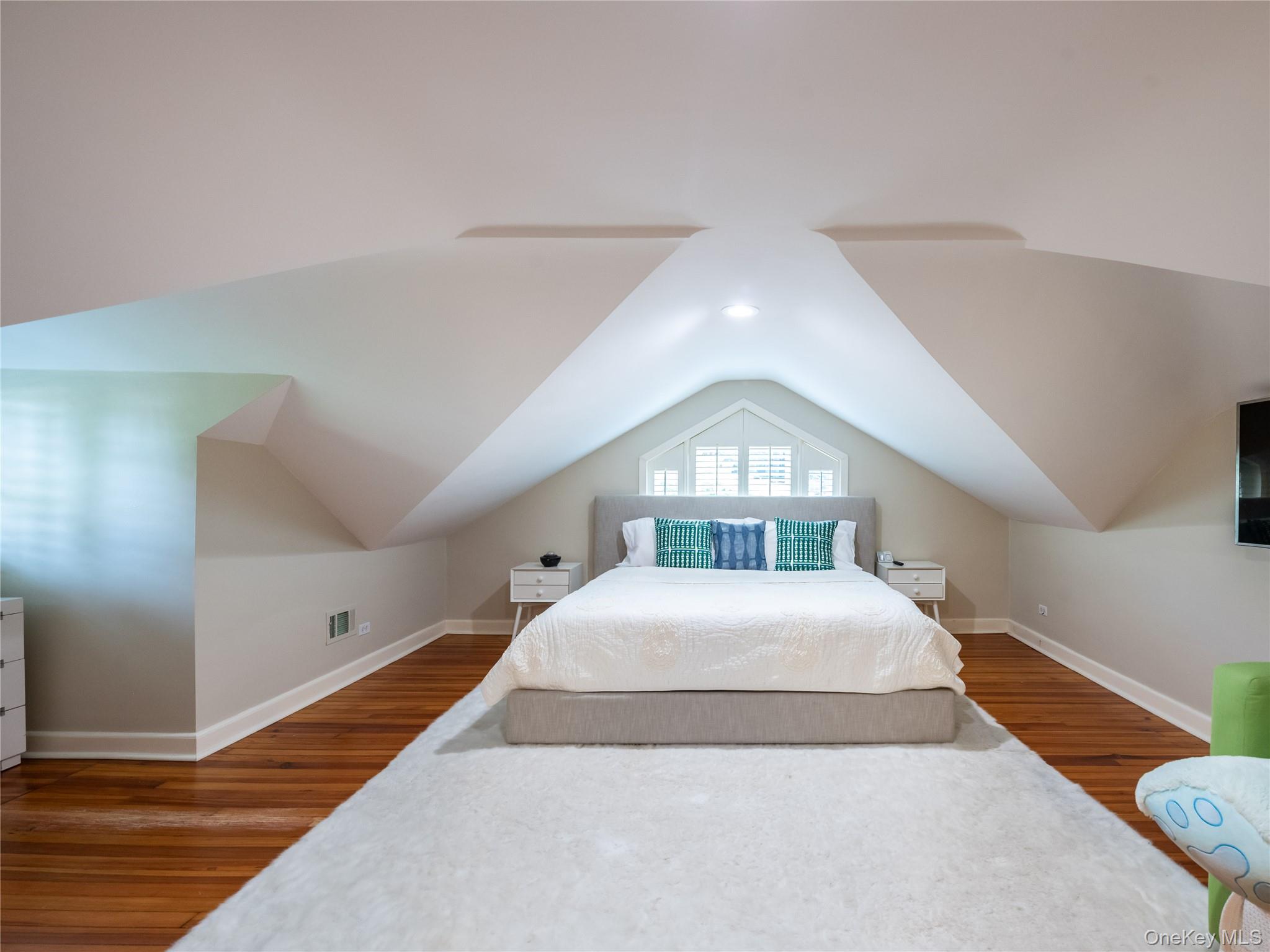 1054 Plandome Road Manhasset, NY 11030 - Photo 19 of 47 a bedroom with a bed and a large window