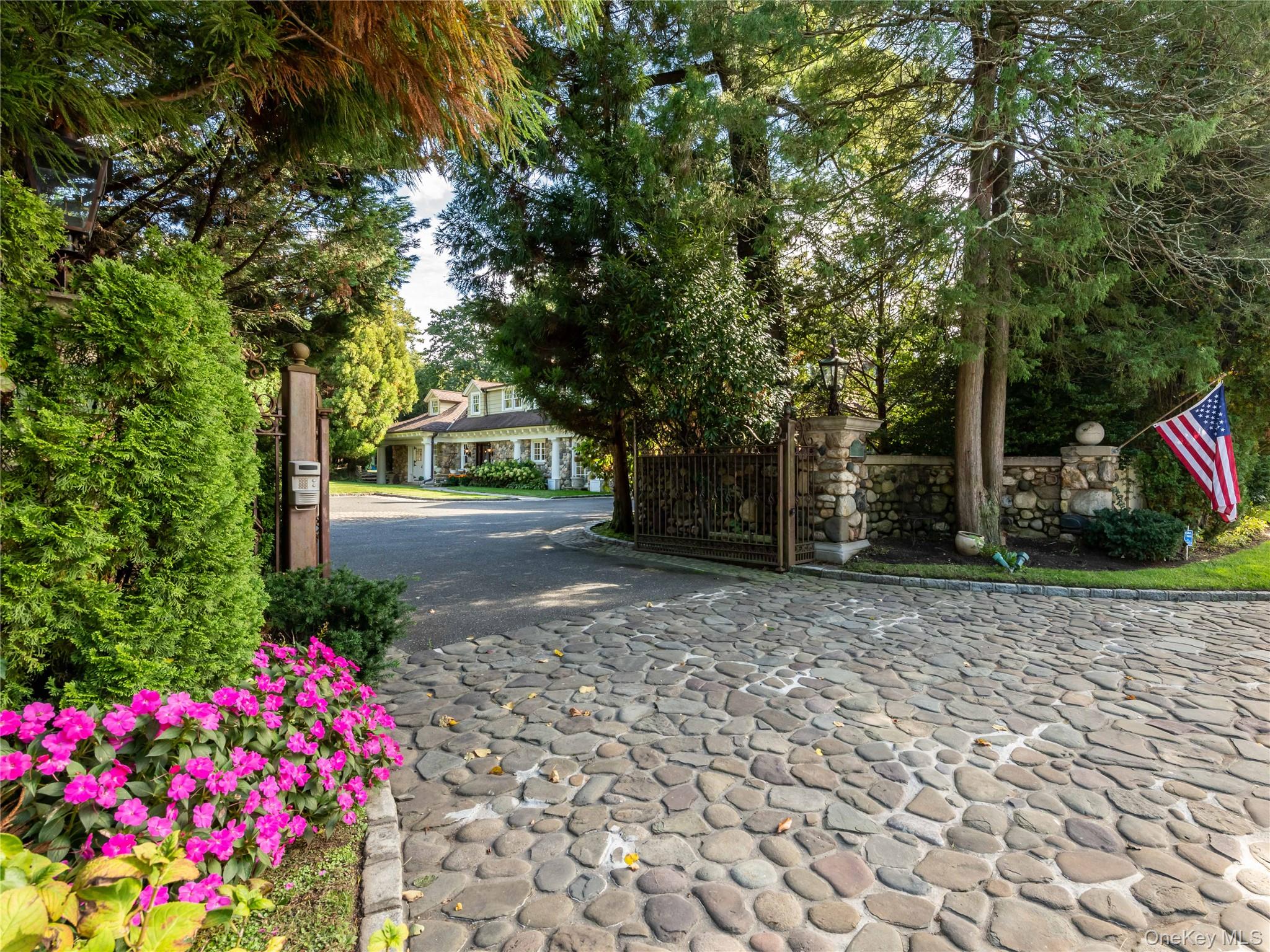 1054 Plandome Road Manhasset, NY 11030 - Photo 2 of 47 a view of a garden with flowers and trees