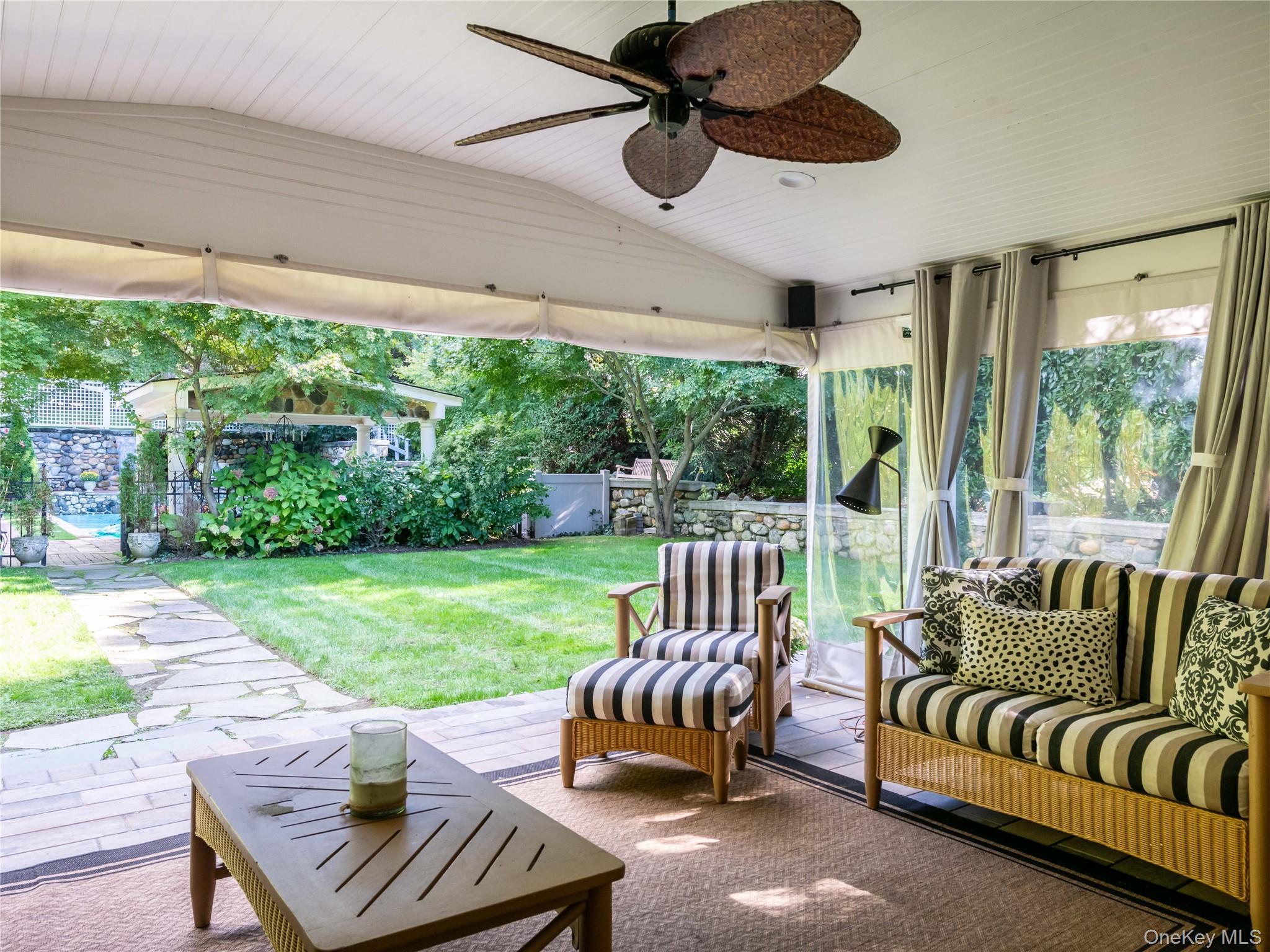 1054 Plandome Road Manhasset, NY 11030 - Photo 22 of 47 a outdoor living space with furniture and a garden