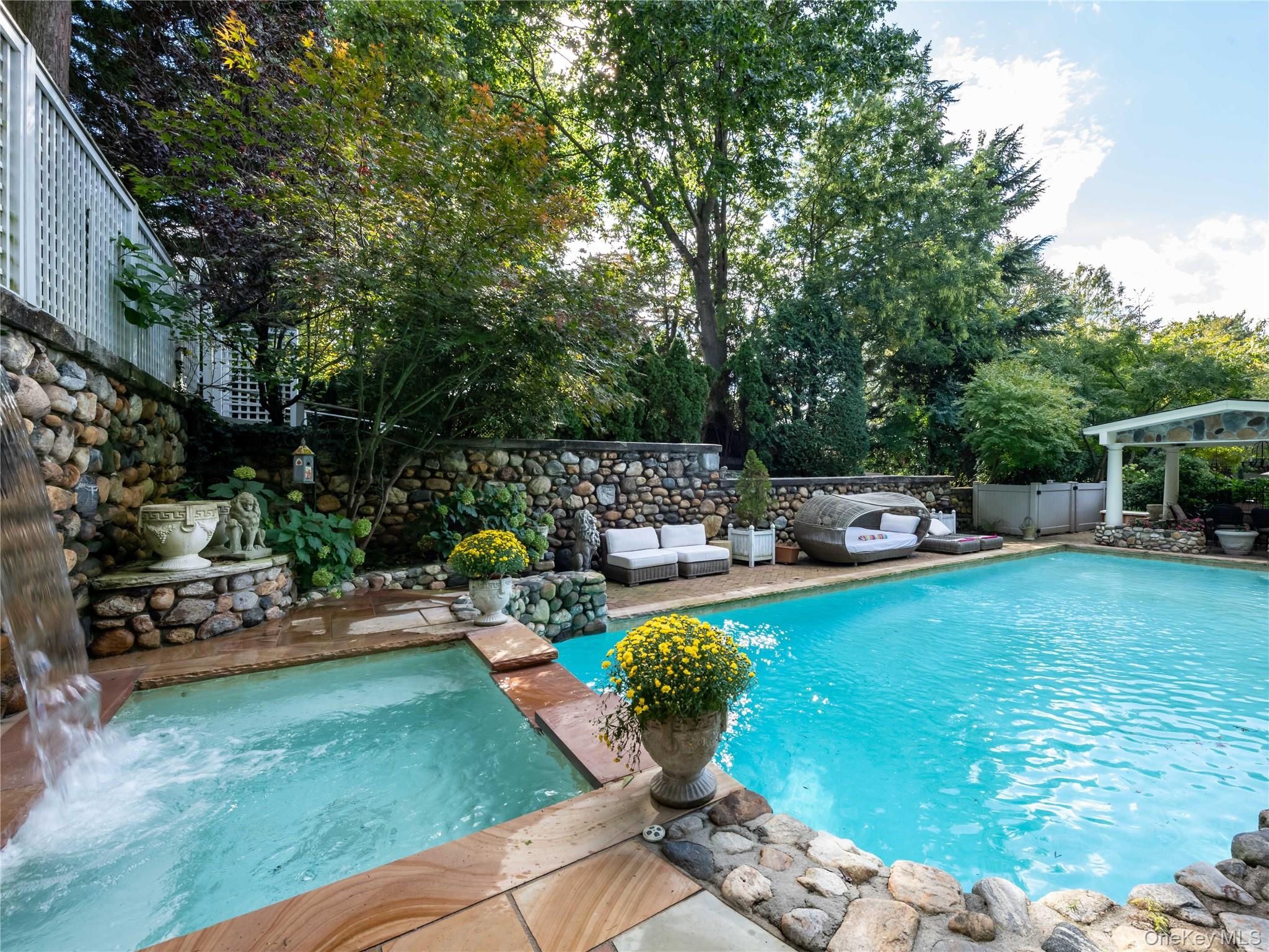 1054 Plandome Road Manhasset, NY 11030 - Photo 26 of 47 a view of a backyard with sitting area