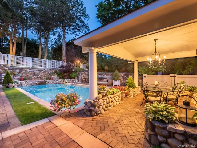 a view of a patio with table and chairs potted plants