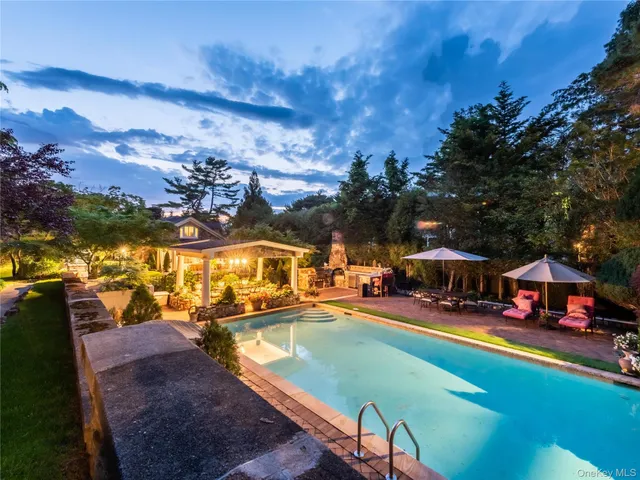 an outdoor space with swimming pool and furniture