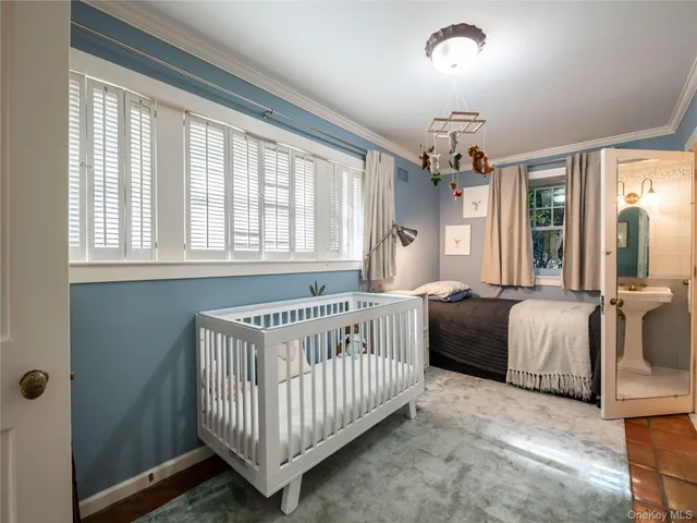 a bedroom with windows and a chandelier