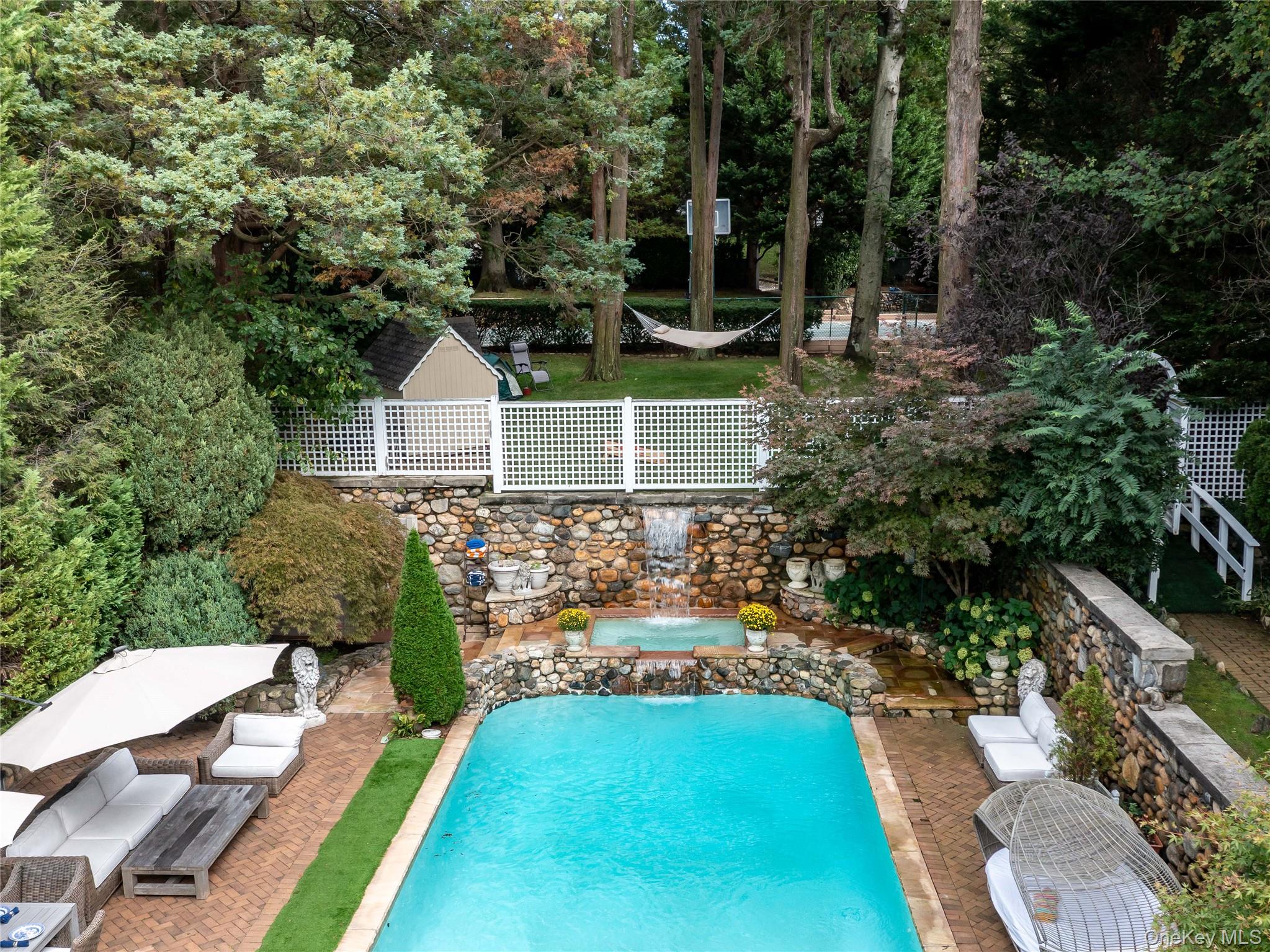 1054 Plandome Road Manhasset, NY 11030 - Photo 38 of 47 a front view of a house with a yard