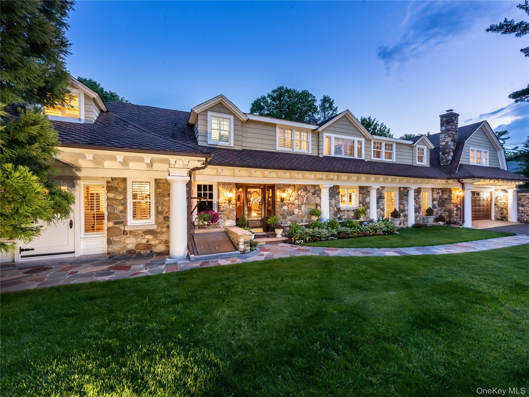 1054 Plandome Road Manhasset, NY 11030 - Photo 4 of 47 front view of a building with a yard