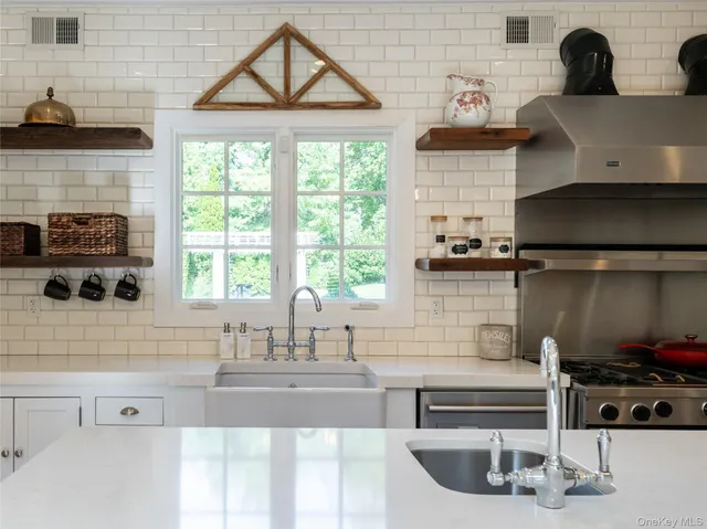 a kitchen with a sink a stove and cabinets