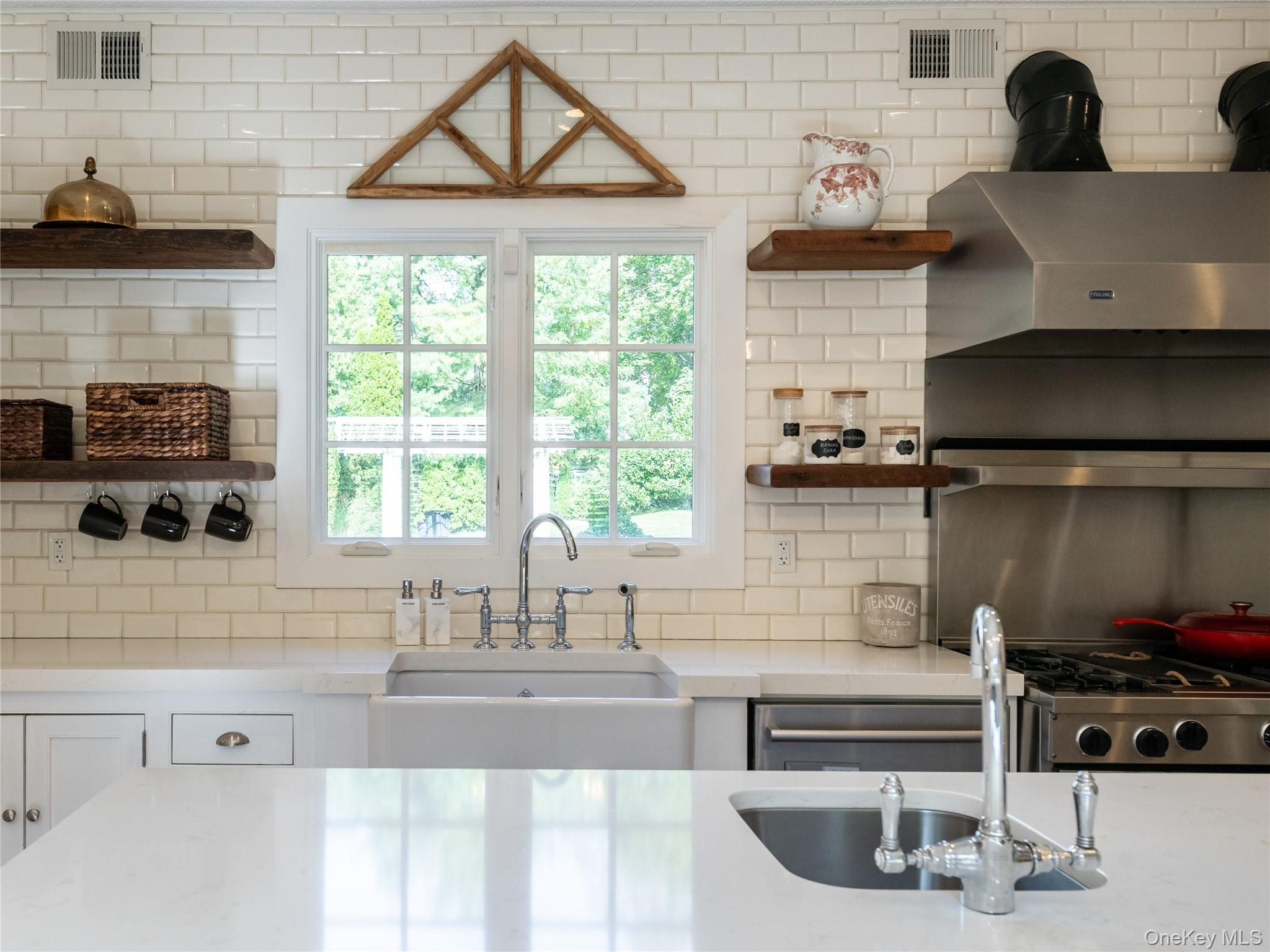 1054 Plandome Road Manhasset, NY 11030 - Photo 7 of 47 a kitchen with a sink a stove and cabinets