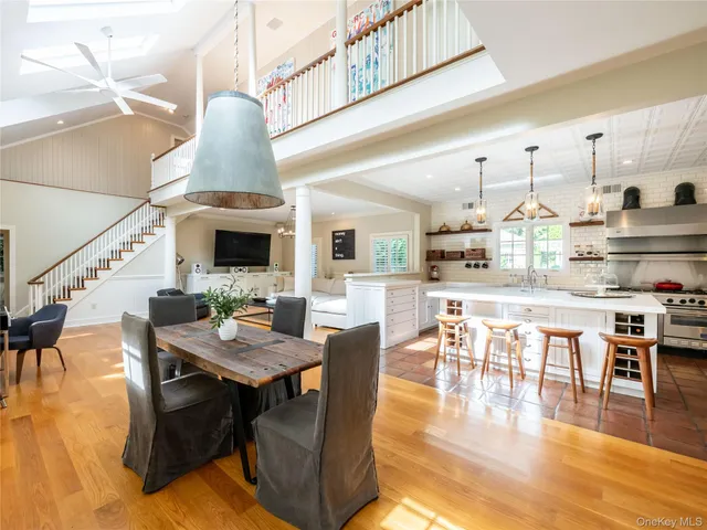a dining room with furniture entryway and wooden floor