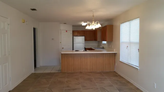 a view of kitchen and kitchen with a sink
