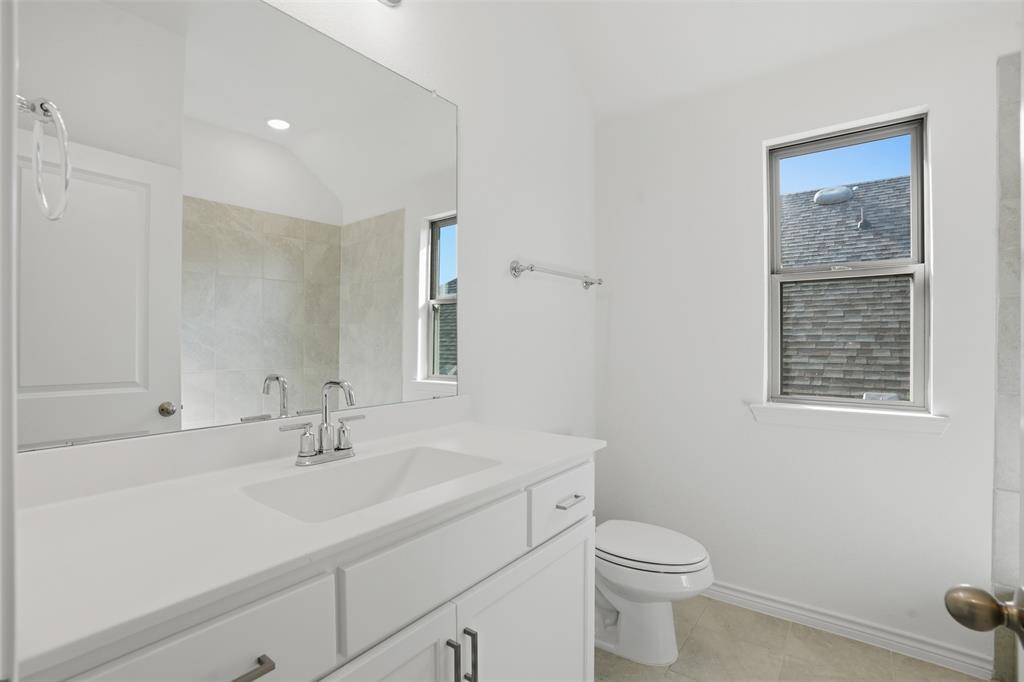 537 Oakmoss Street Little Elm, TX 76227 - Photo 19 of 39 a bathroom with a sink toilet and a mirror