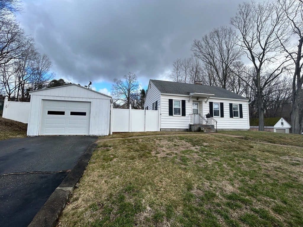 73 Sand Street Gardner, MA 01440 - Photo 2 of 23 a front view of a house with a garden and yard