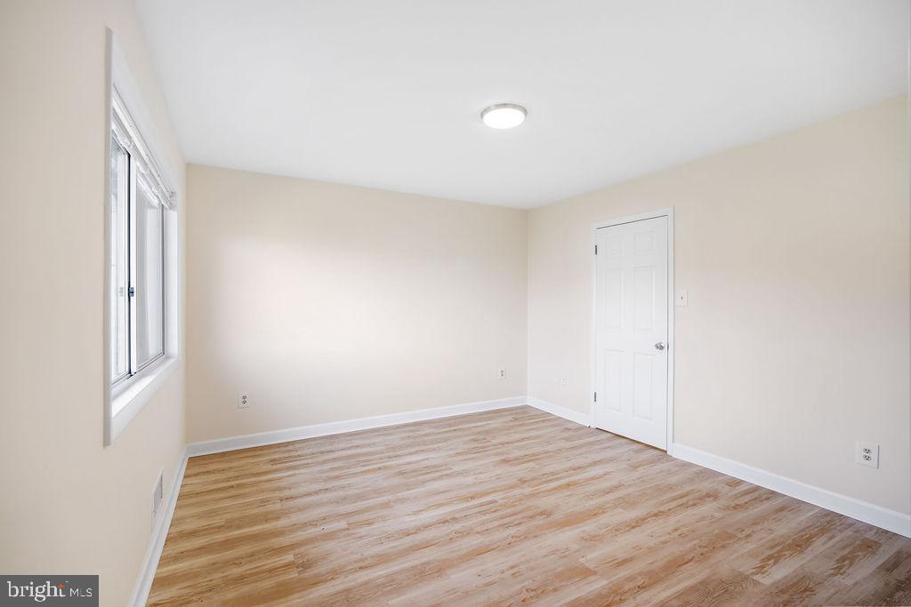 2201 Chamblee Place Herndon, VA 20170 - Photo 17 of 31 a view of an empty room with wooden floor and a window