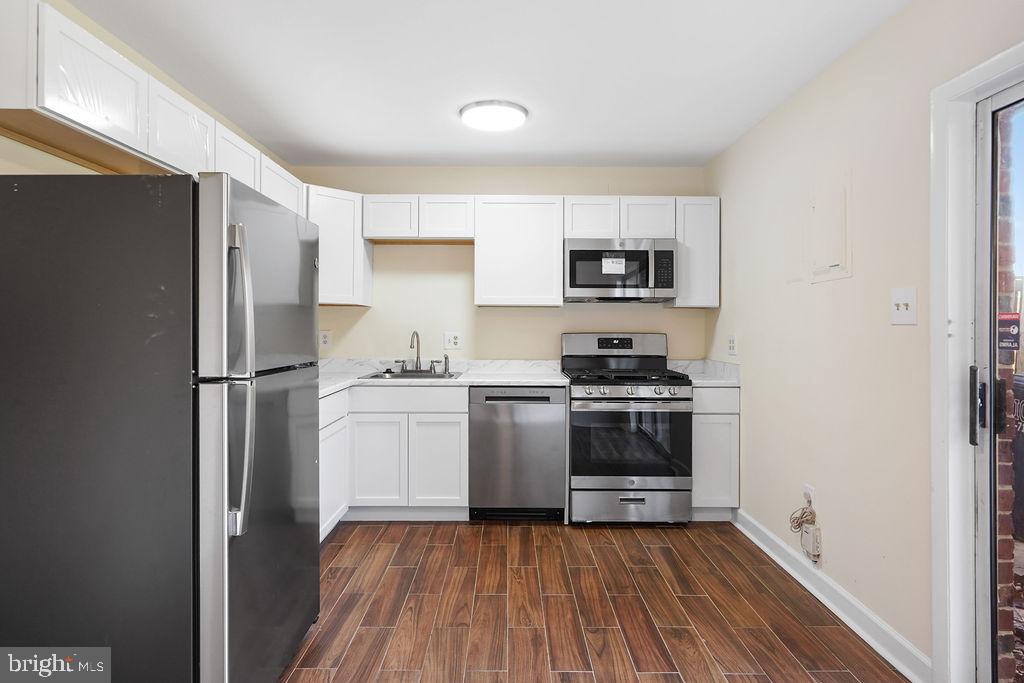 2201 Chamblee Place Herndon, VA 20170 - Photo 5 of 31 a kitchen with a refrigerator and a stove top oven