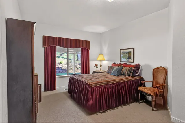 a bedroom with furniture and a window