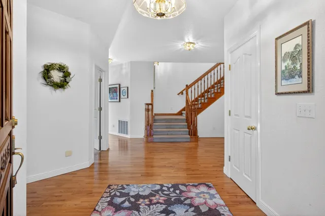 a dining room with furniture a chandelier and window