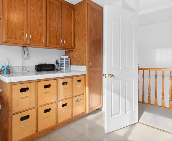 a bedroom with a bed lamp and a large window