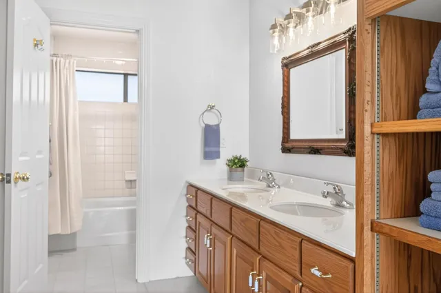 a bedroom with a bed and large window