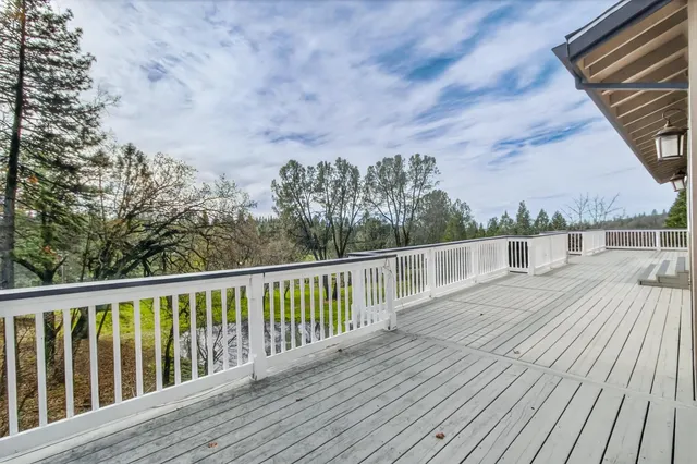 a balcony with wooden floor and fence