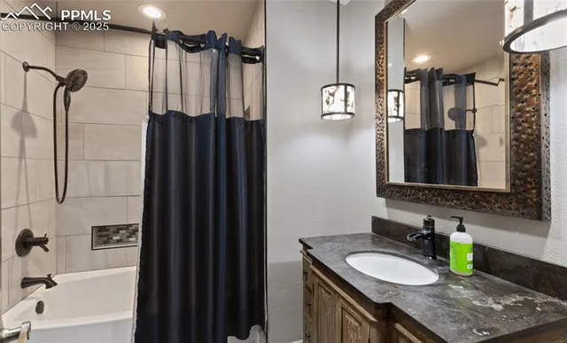 a bathroom with a granite countertop sink toilet a mirror a shower and a mirror