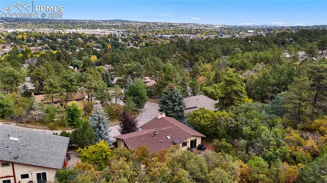 an aerial view of a house with a yard