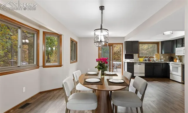 a view of a dining room with furniture wooden floor and chandelier