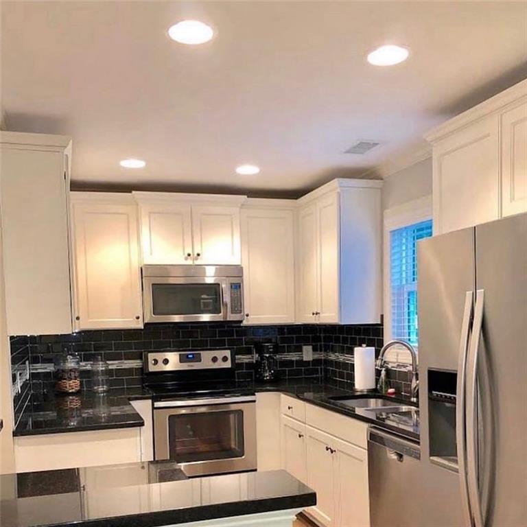 535 Forrest Avenue Gainesville, GA 30501 - Photo 2 of 6 a kitchen with granite countertop a refrigerator stove and sink