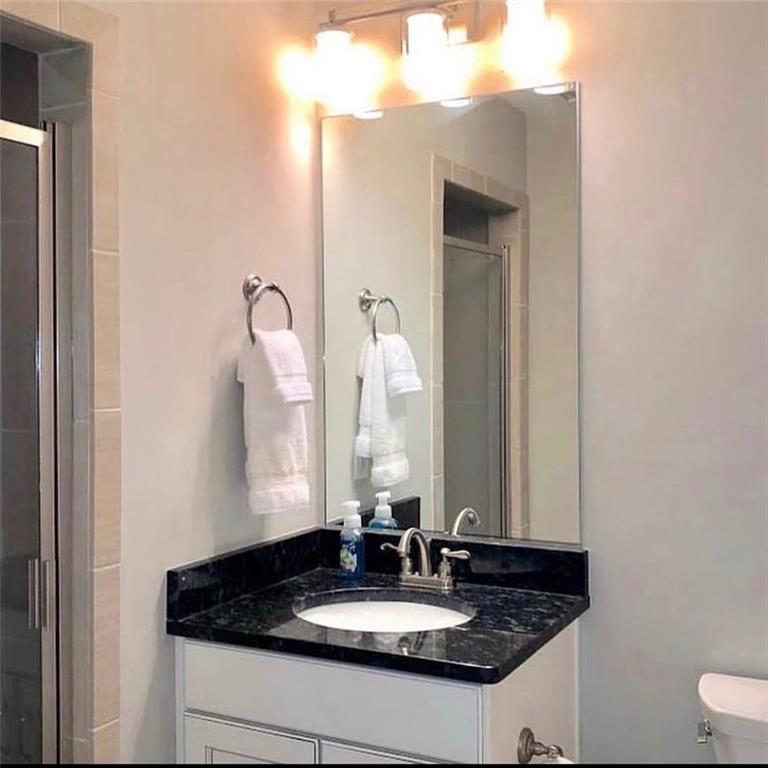 535 Forrest Avenue Gainesville, GA 30501 - Photo 4 of 6 a bathroom with a sink and a mirror