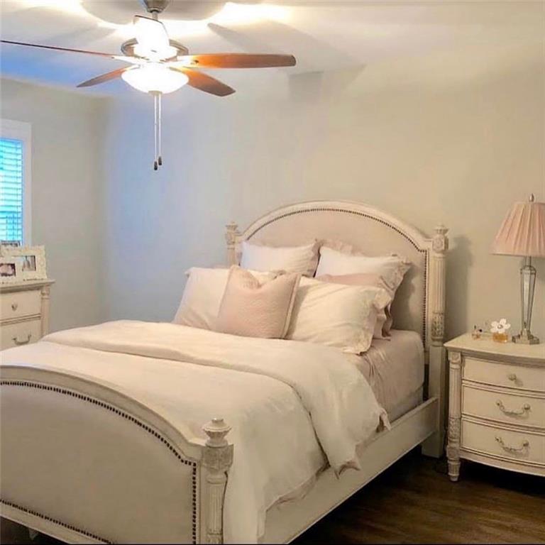 535 Forrest Avenue Gainesville, GA 30501 - Photo 5 of 6 a bedroom with a bed and a chandelier