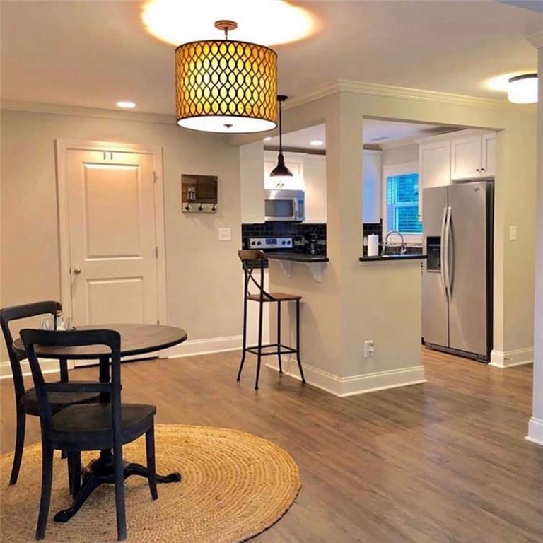 535 Forrest Avenue Gainesville, GA 30501 - Photo 6 of 6 a kitchen with stainless steel appliances granite countertop a stove a refrigerator and a dining table with wooden floor