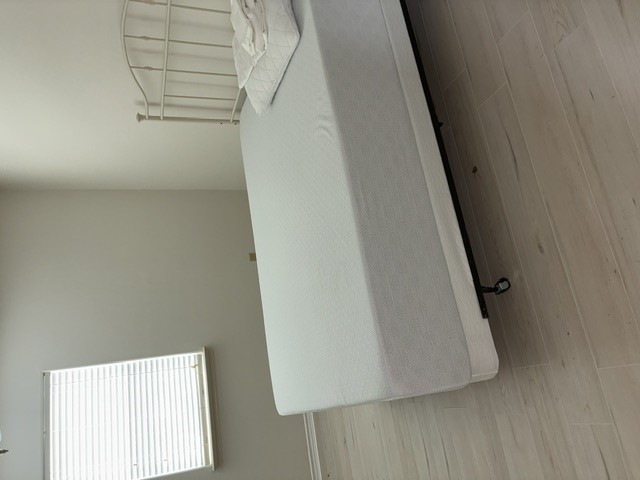 404 West 24th Street Bryan, TX 77803 - Photo 20 of 22 a bed sitting in a room next to a window