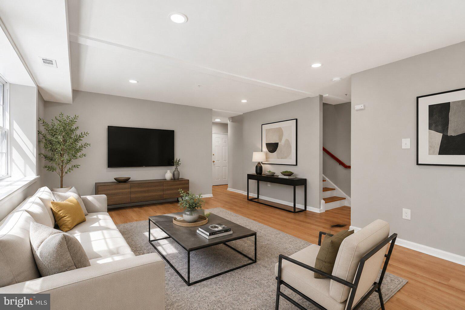 1008 Rittenhouse Street Northwest, Unit 15 Washington, DC 20011 - Photo 3 of 39 a living room with furniture and a flat screen tv