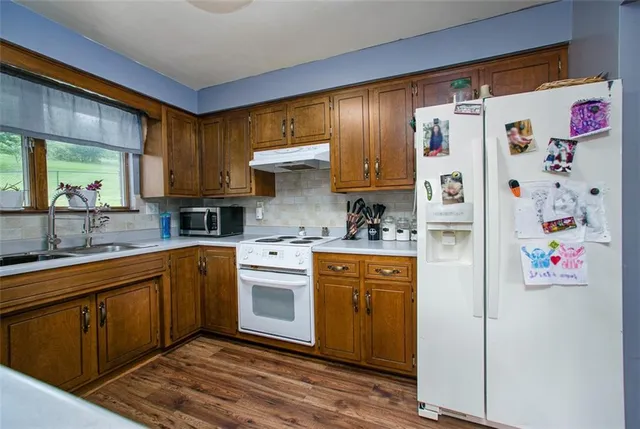 a kitchen with stainless steel appliances a refrigerator sink and cabinets