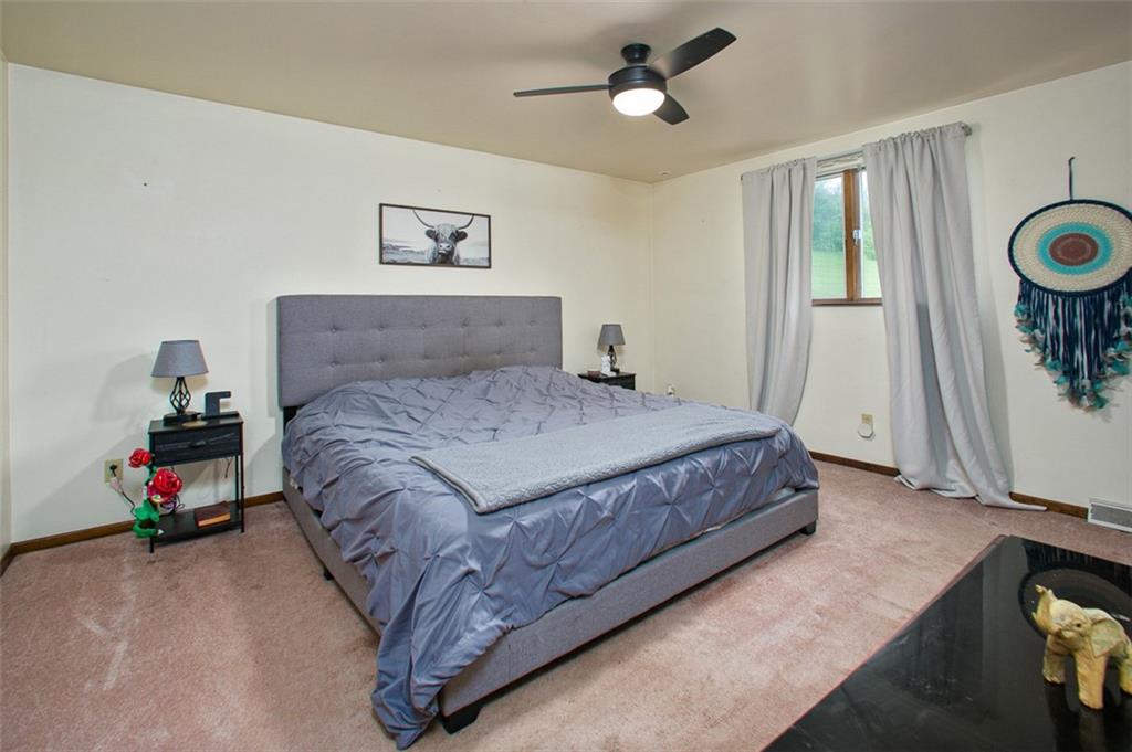 512 Leckrone-Highhouse Road McClellandtown, PA 15458 - Photo 20 of 34 a bedroom with a bed and a chandelier