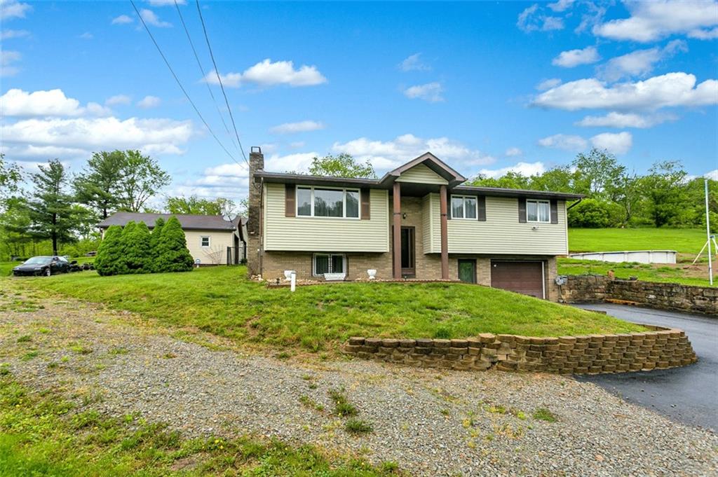512 Leckrone-Highhouse Road McClellandtown, PA 15458 - Photo 2 of 34 a view of a big house with a big yard and large trees