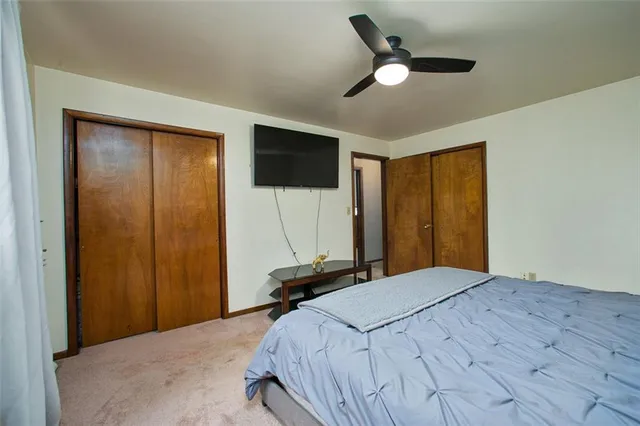 a bedroom with a bed and a large mirror