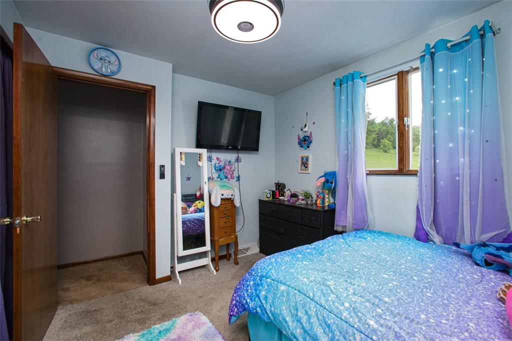 512 Leckrone-Highhouse Road McClellandtown, PA 15458 - Photo 23 of 34 a bedroom with a bed and a flat tv screen