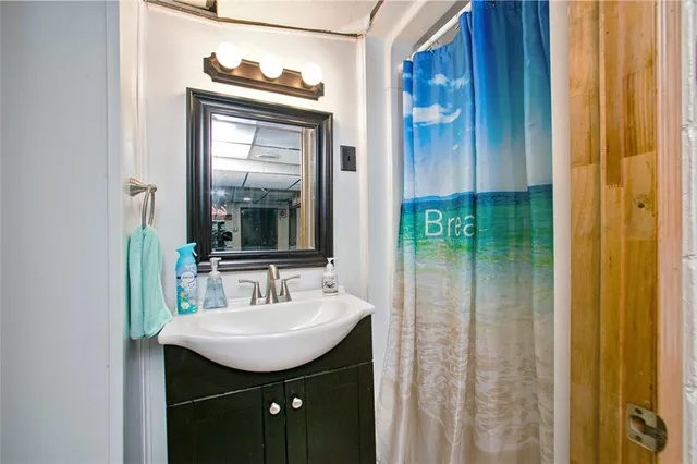 a bathroom with a sink a mirror a vanity and window