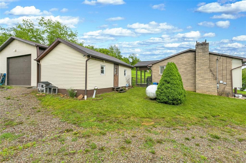 512 Leckrone-Highhouse Road McClellandtown, PA 15458 - Photo 5 of 34 a view of a backyard with plants and a garden