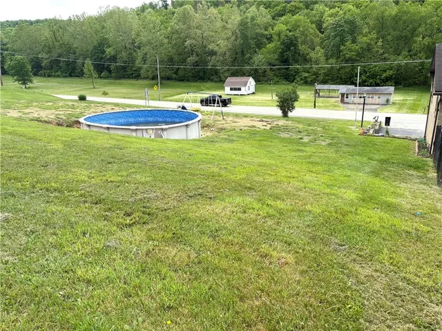 a view of a swimming pool with a yard