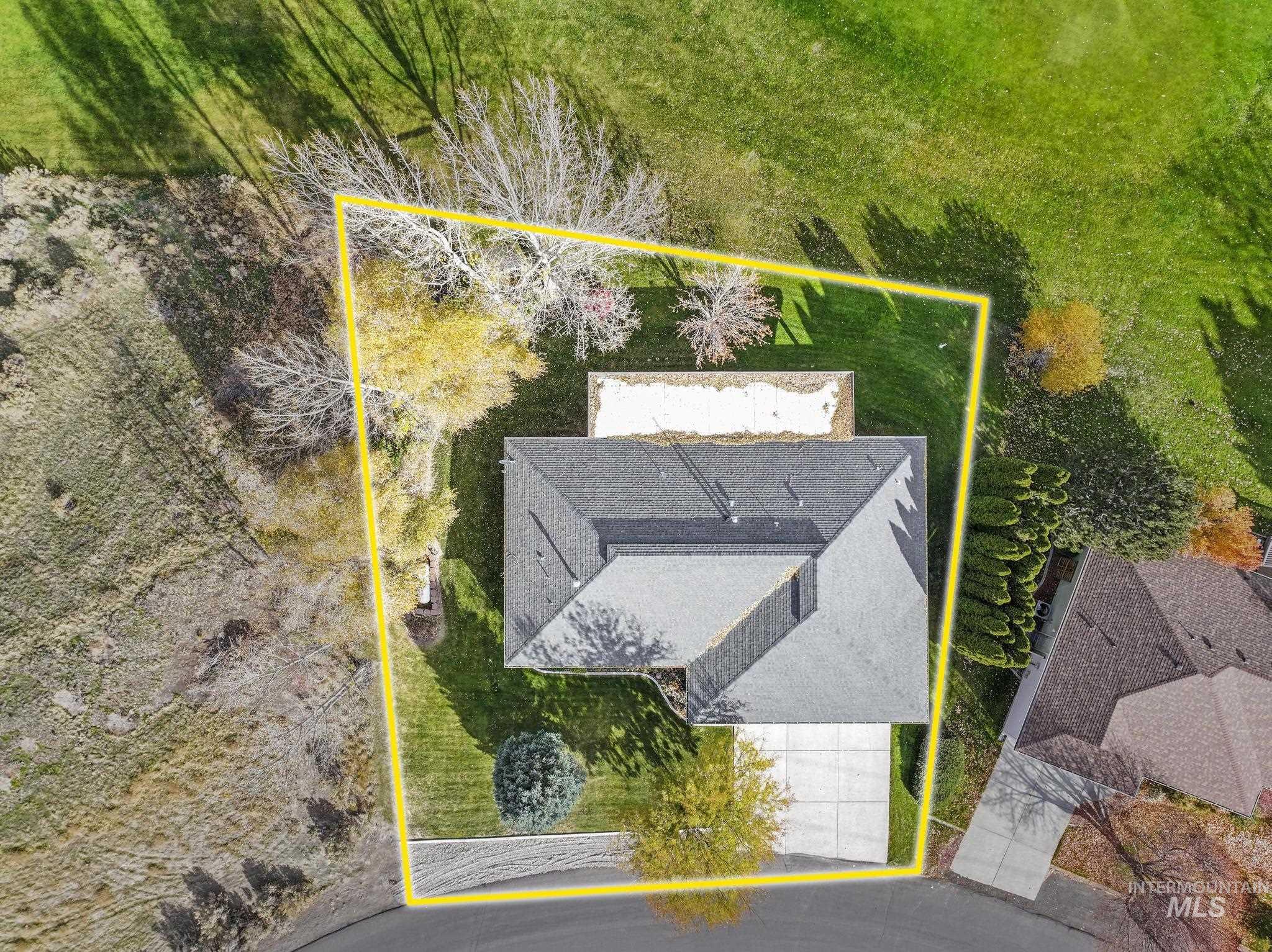 100 Olympic Road Jerome, ID 83338 - Photo 46 of 50 Single-family residence with a dark gray shingle roof, concrete driveway, and surrounding green lawn