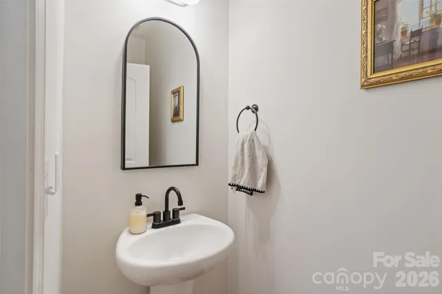 a bathroom with a sink a mirror and vanity