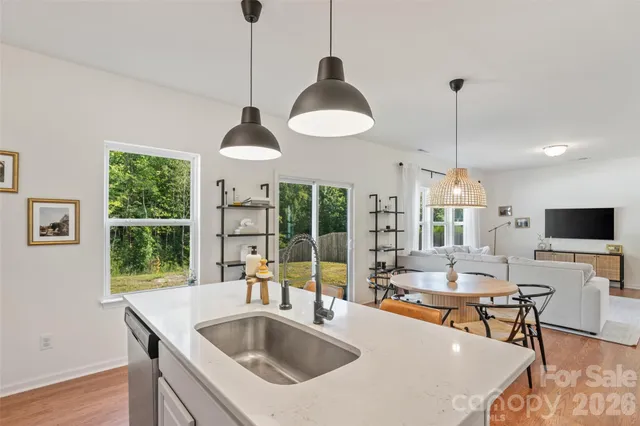 a living room with furniture and a refrigerator