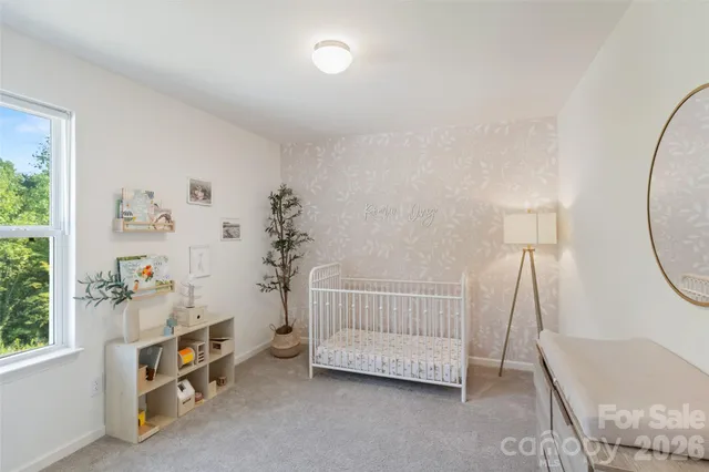 a room with a bed a mirror and a window