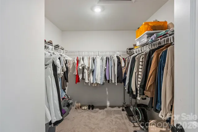 a spacious bedroom with a bed and a flat screen tv