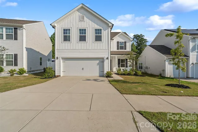 a view of a white house with a yard