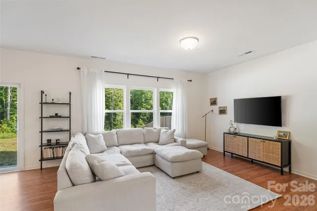 a living room with furniture and a dining table