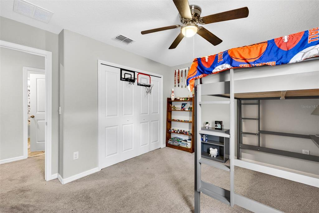 9616 Lemon Drop Loop Sun City Center, FL 33573 - Photo 36 of 53 a room with lots of white walls and ceiling fan
