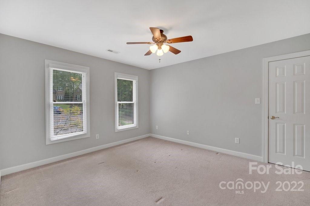 656 Amberly Crossing Fort Mill, SC 29708 - Photo 20 of 44 an empty room with windows and ceiling fan